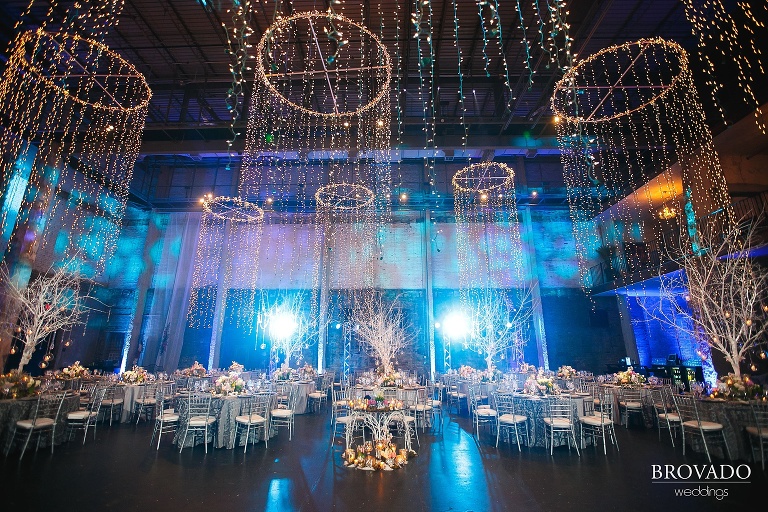 Wide angle of wedding reception setup with handing lights and trees
