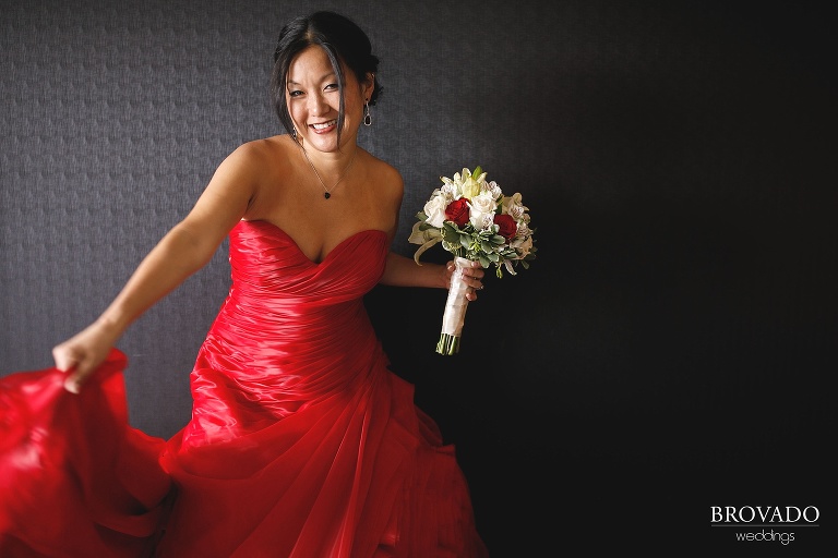 Christine swinging her red wedding dress back and forth