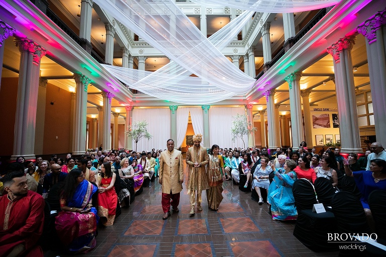 Rishi and his parents walking down the aisle at landmark center