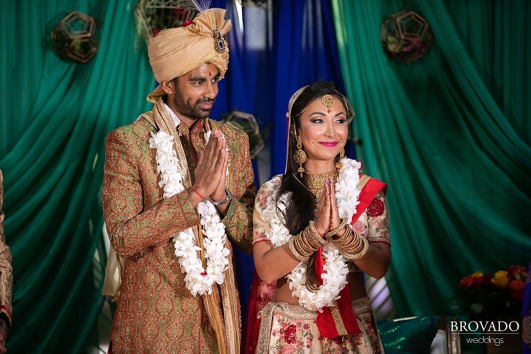 Rishi and Lorena holding their hands in prayer