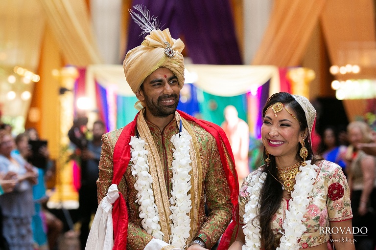 Smiling bride and groom walking back down aisle
