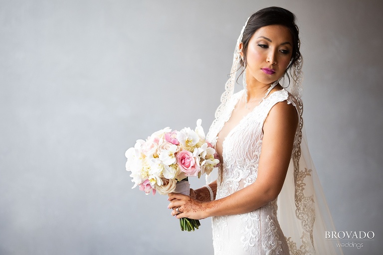 Moody bridal portrait with pink lips and bouquet