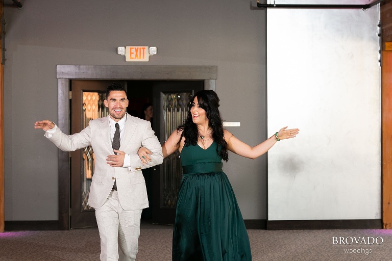 Wedding party dancing into reception