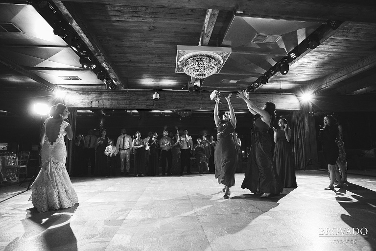 Bridesmaids jumping to catch the bouquet