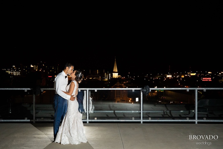 Rishi and Lorena kissing on a'bulae rooftop at night