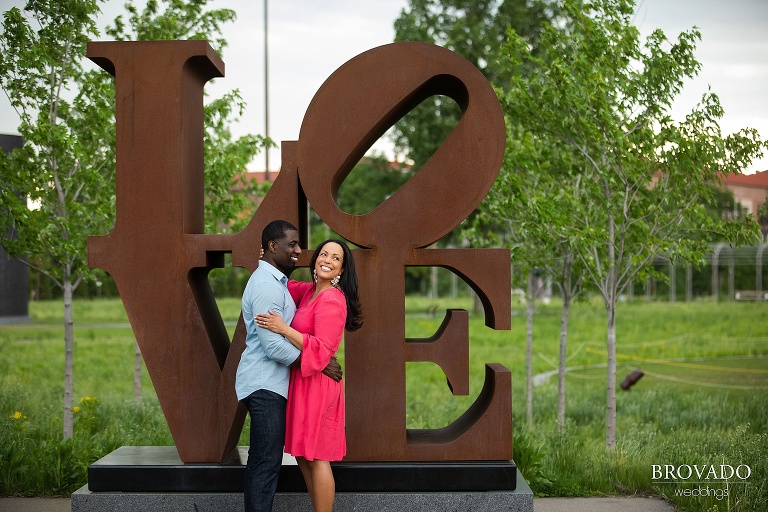 Taara and Glenn in front of love sign at sculpture garden