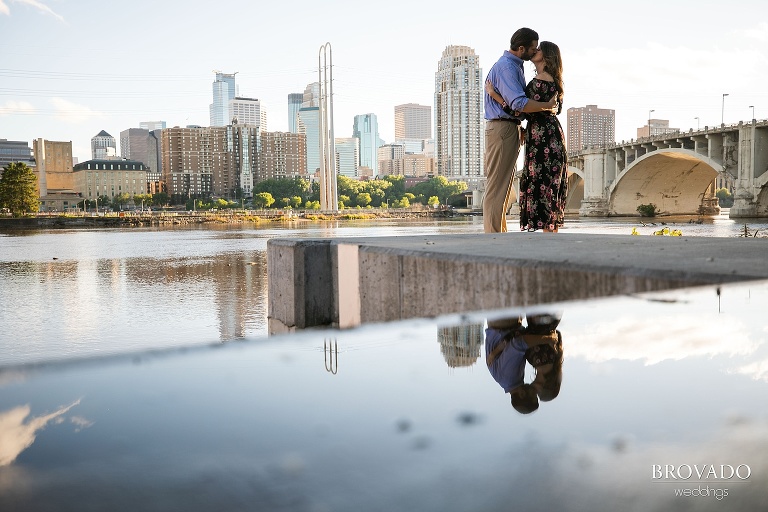 Karen and Matthew kissing in front of minneapolis skyline