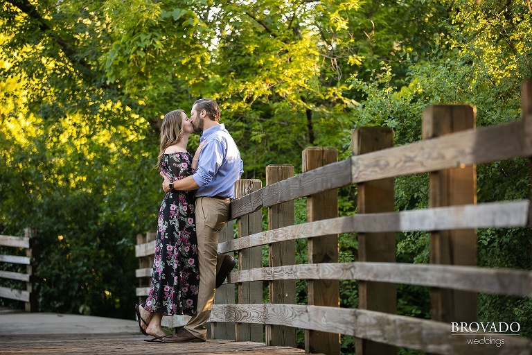 Karen and Matthew kissing on a bridge