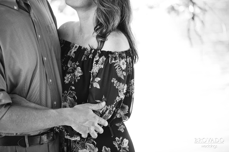 Black and white close up of fiances holding each other