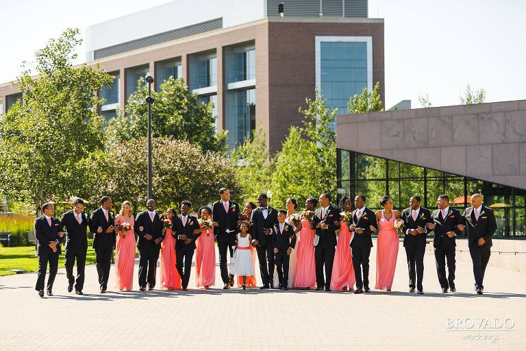 Wedding party walking with arms linked