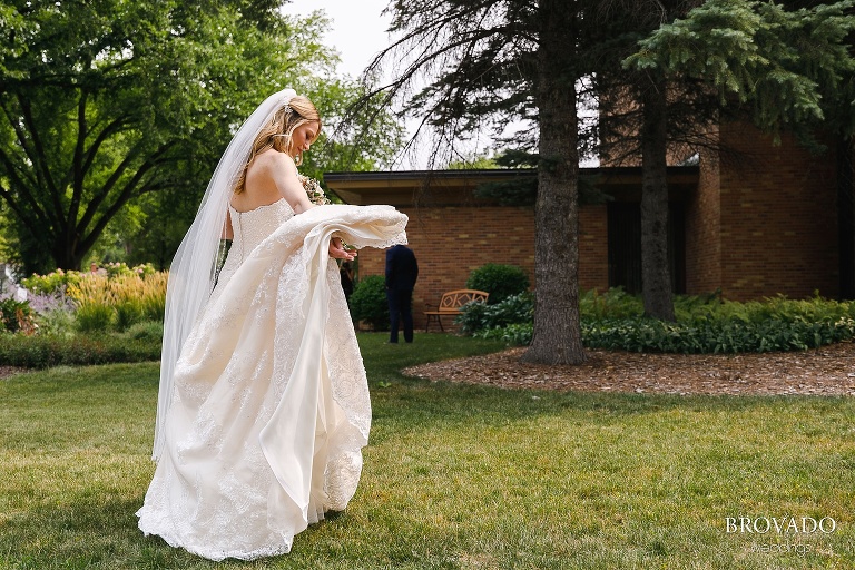 Bride spreading out her dress before her first look