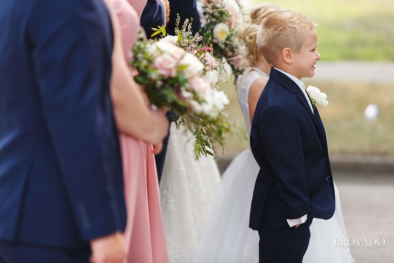 Ring bearer posing next to flower girl