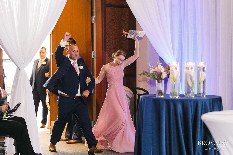 Wedding party cheers during grand entrance