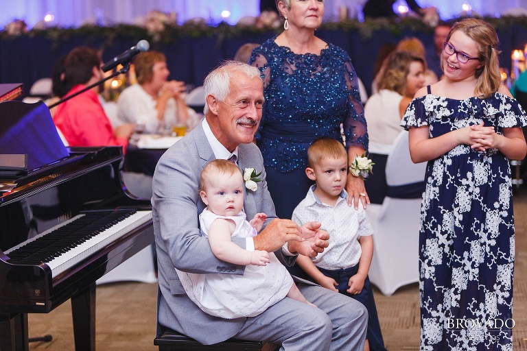 Father of the groom claps during grand entrance