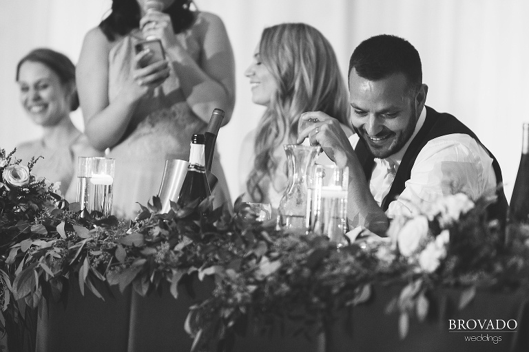 Groom laughing during speeches