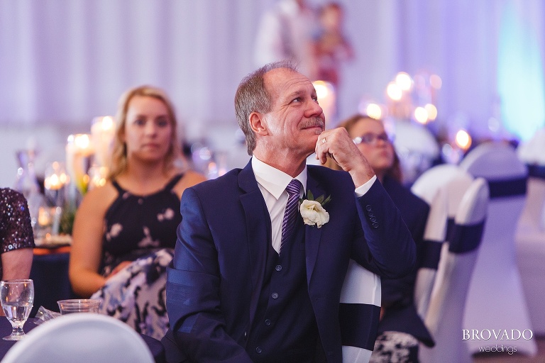 Father of the bride smiling from his table