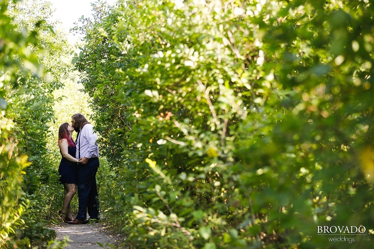 Bethany and Andy kissing on trail near St. Anthony Main