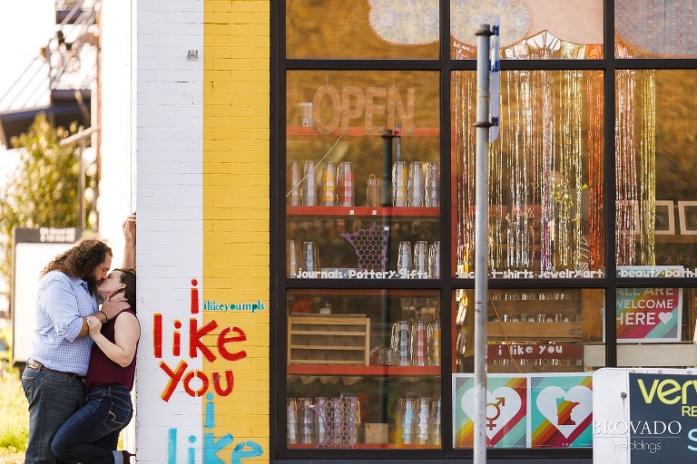 Bethany and Andy kissing in front of I Like You