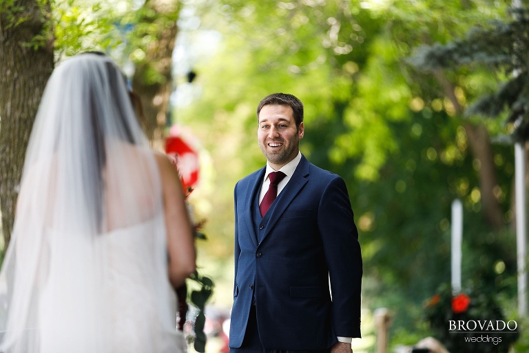Groom smiling during first look