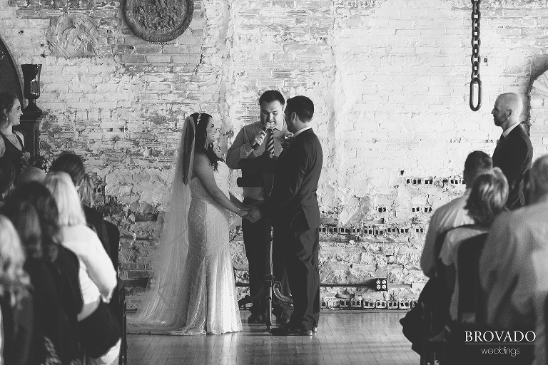 Bride and groom holding hands during ceremony
