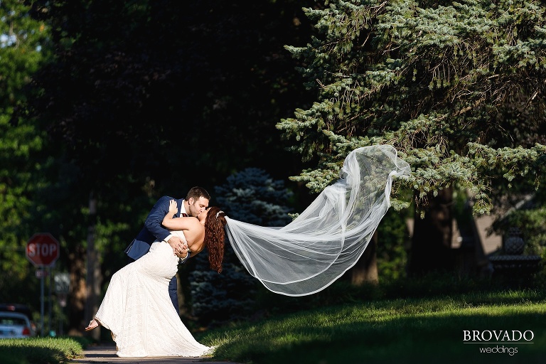 Brian dipping Jacquelyn with her veil tossed in the air