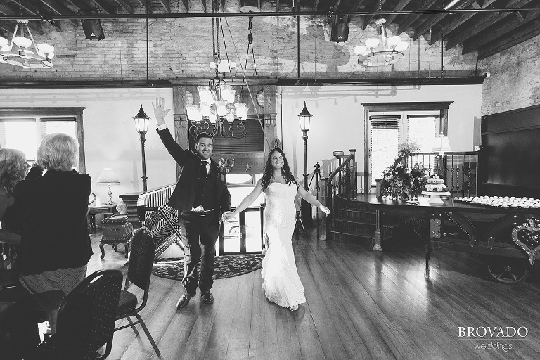 Jacquelyn and Brian cheerfully enter wedding reception