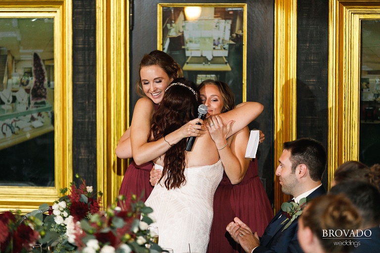 Bride hugging her bridesmaids after speech