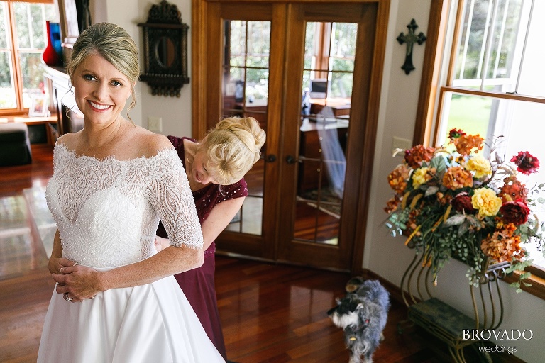 Karen's mother in law helping her put on her dress