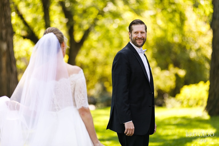 Groom smiling during first look