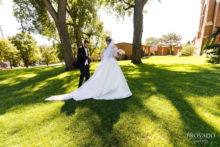 Karen leading Matthew across the church lawn