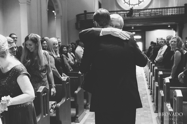 Father of the groom hugging Matthew in church