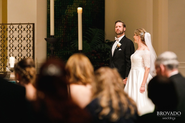 Groom looks out into crowd at ceremony
