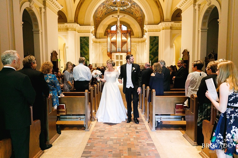 Bride and groom walking out of the church