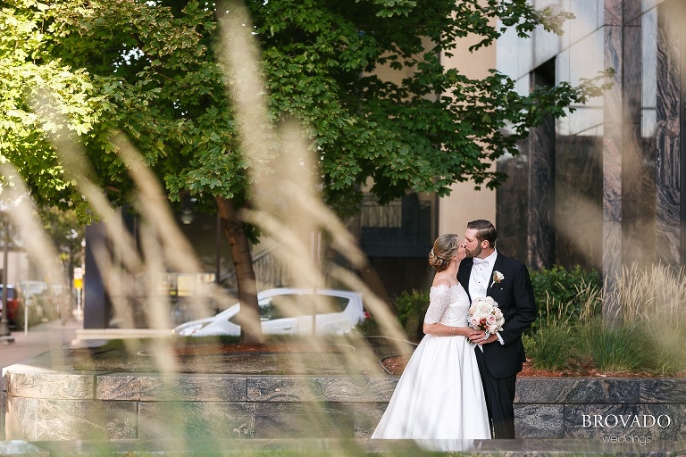 Karen and Matthew kissing in front of marble building