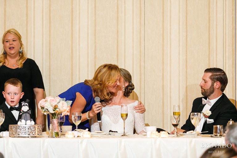 Bride kissing her friend on the cheek