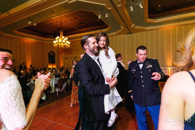 Groom dancing with the flower girl