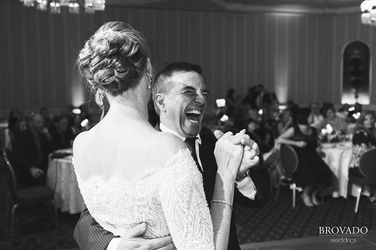 Bride laughing and dancing with friend