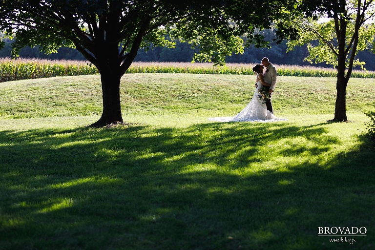 Kelly and Robert kissing under tree