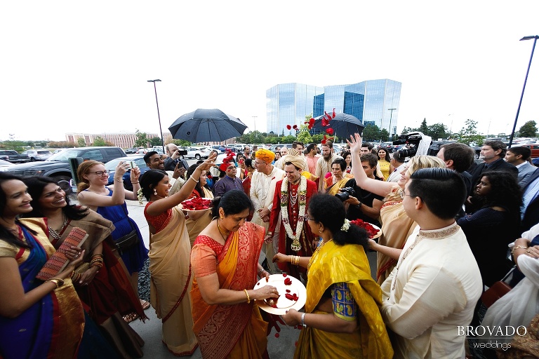 Bride's family throwing flower petals over the groom