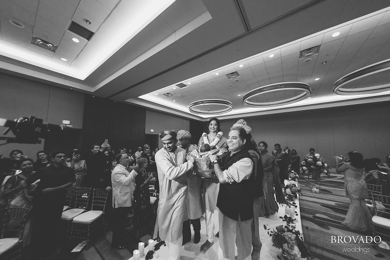 Sruti being carried down the aisle in a basket