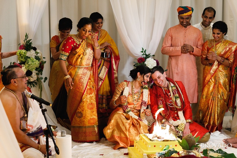Sruti and Ethan laughing during their wedding ceremony