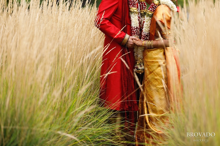 Closeup of bride and groom holding hands