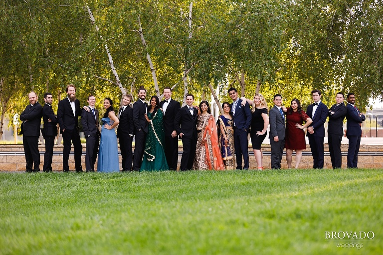 Entire wedding party posing on lawn