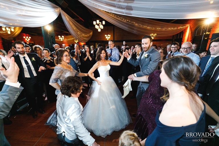 bride and groom dancing with their family