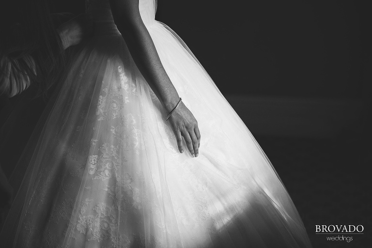 Close up black and white photo of bride's bracelet in the sun