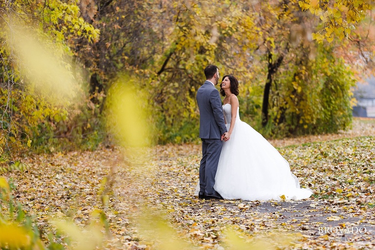 Bride and groom laughing on the path outside of Nicollet Island Pavilion