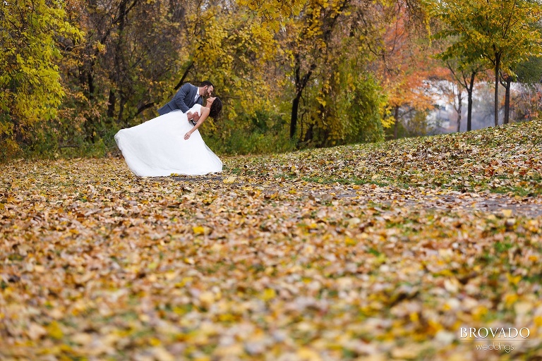 classic dipping wedding photo on fall leaves