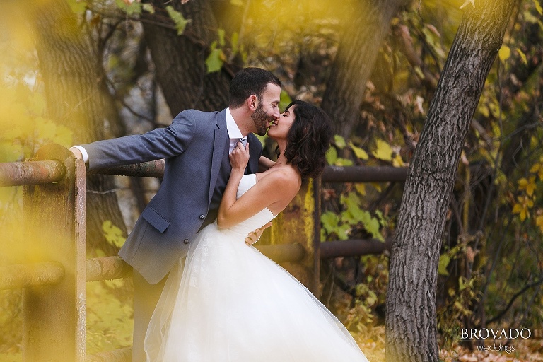 Stephanie and Loren kissing through the leaves