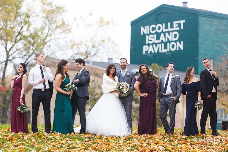 Wedding party posing in front of Nicollet Island Pavilion