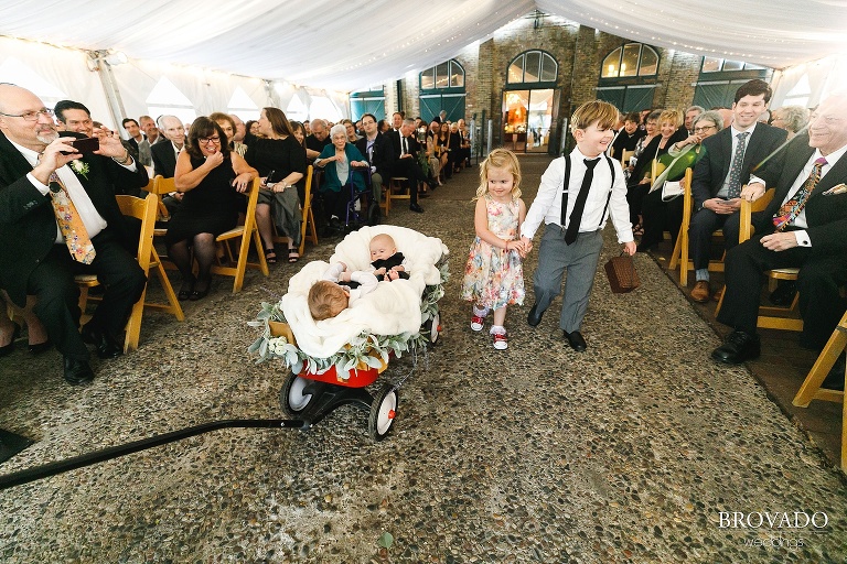 ringbearers and flower girls walking down the aisle